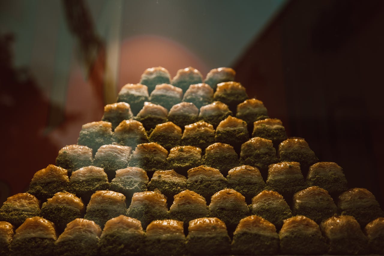 Stack of appetizing baklava desserts in a bakery display.
