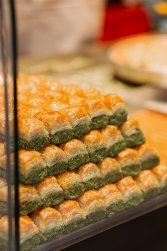 Vertical shot of stacked baklava in Istanbul, highlighting its layered pastry and pistachio filling.